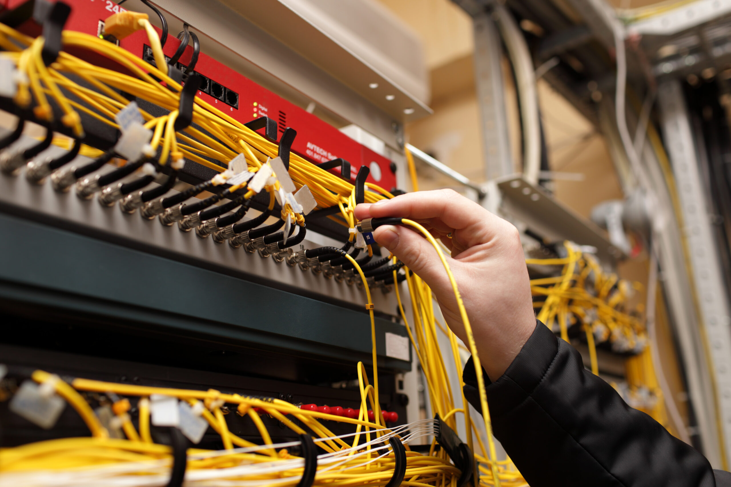 The technician attaching fiber optic on the telecom site